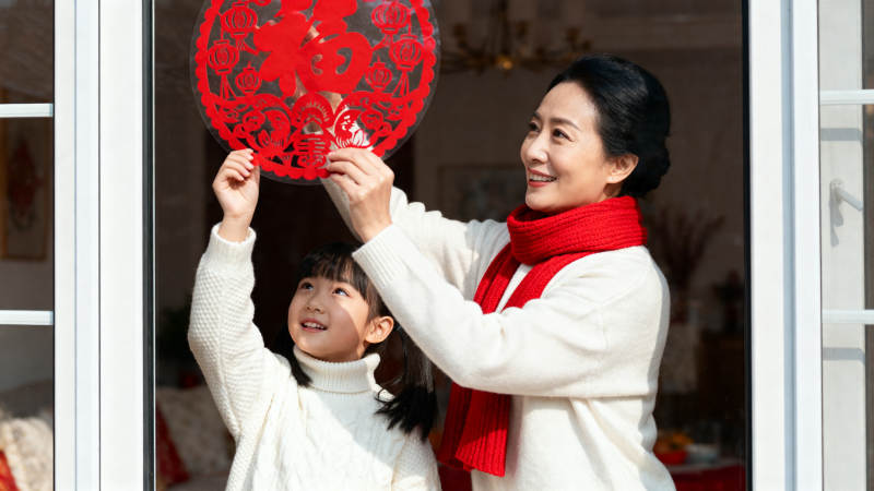 母女贴窗花迎新春图片