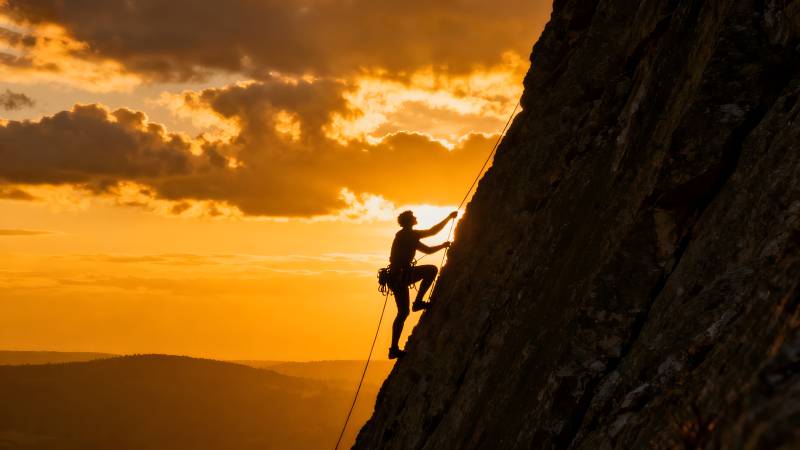 攀岩者剪影日落图片