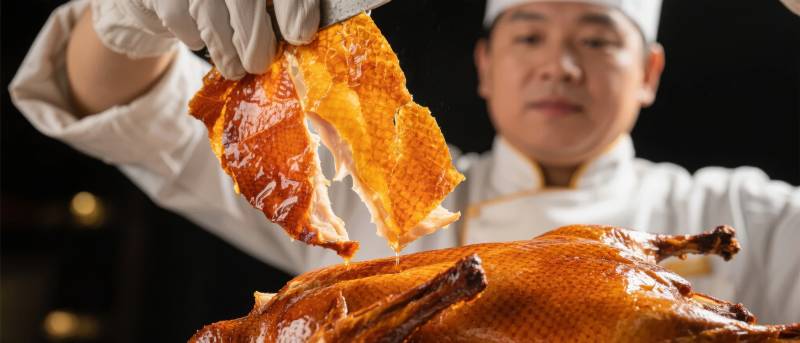 烤鸭师傅展示脆皮图片