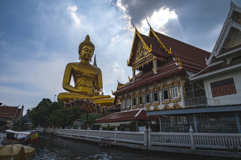 金色佛像临水而立图片