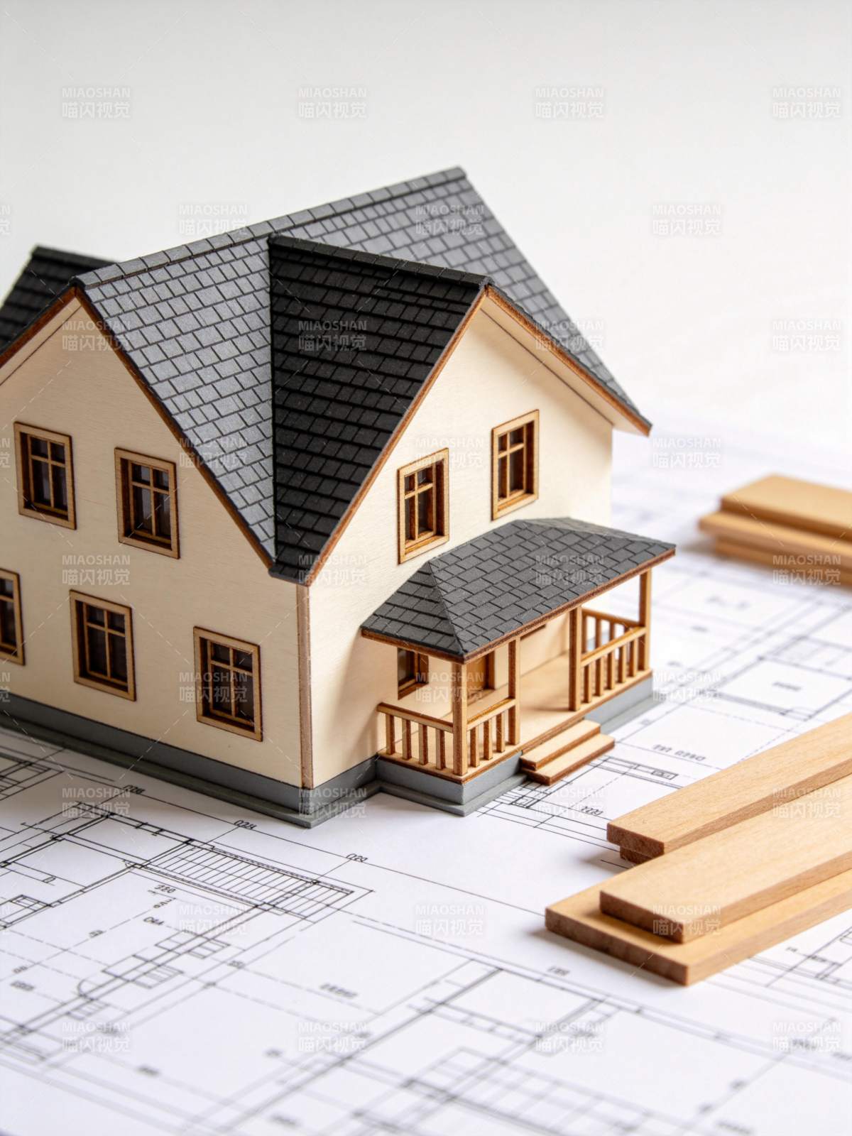 房屋模型置于建筑图纸与木料之上展示图片