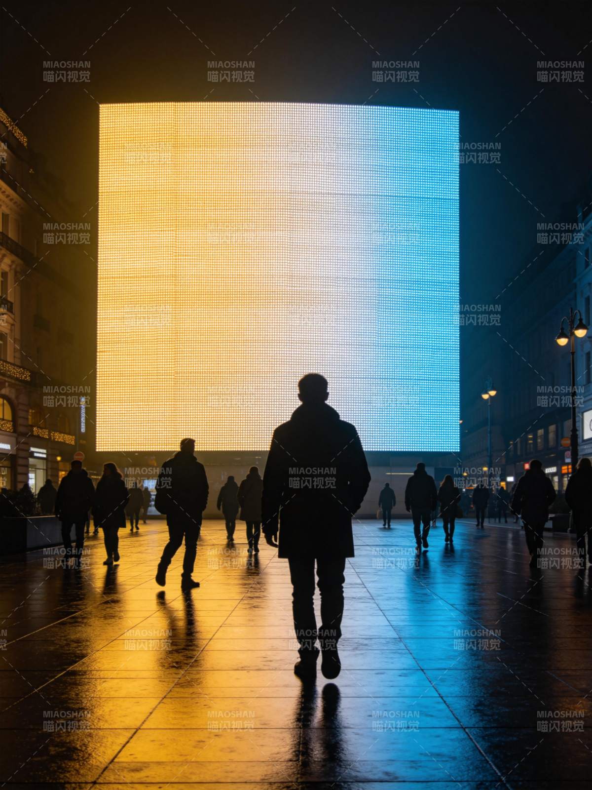 夜晚广场行人背影与巨型渐变LED屏幕图片
