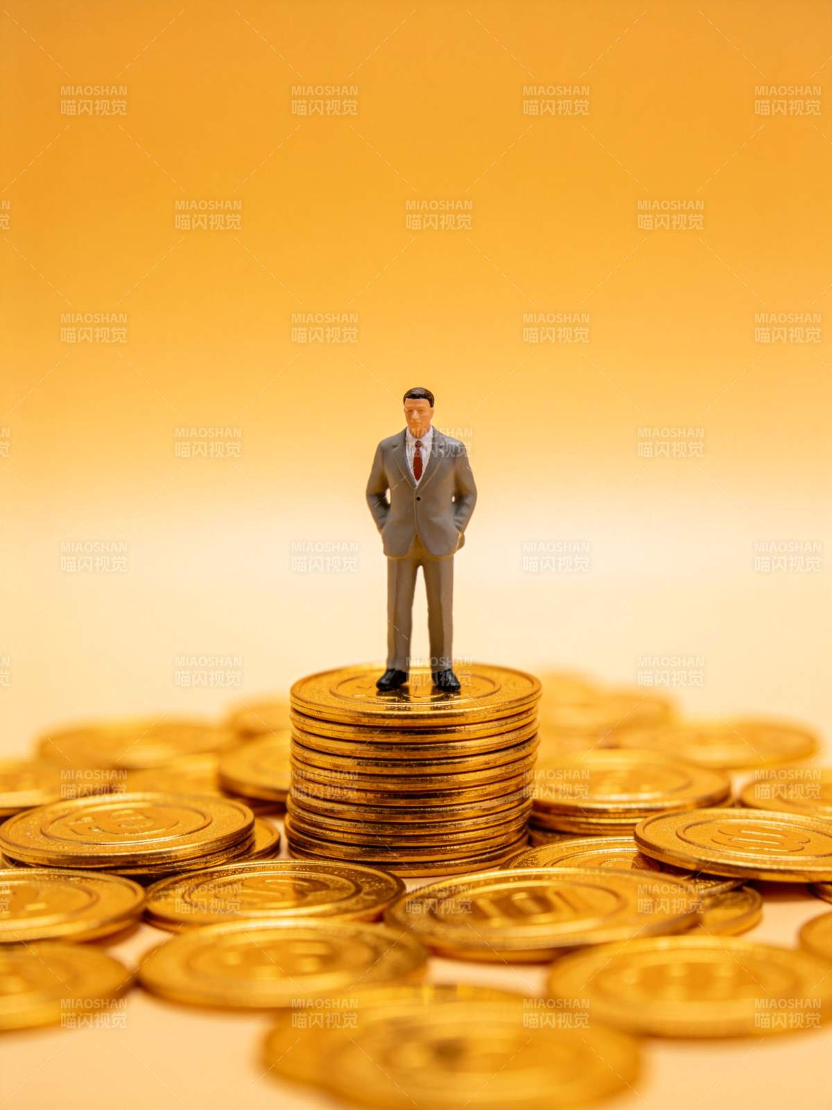 微型商人模型站立在金币堆顶部图片