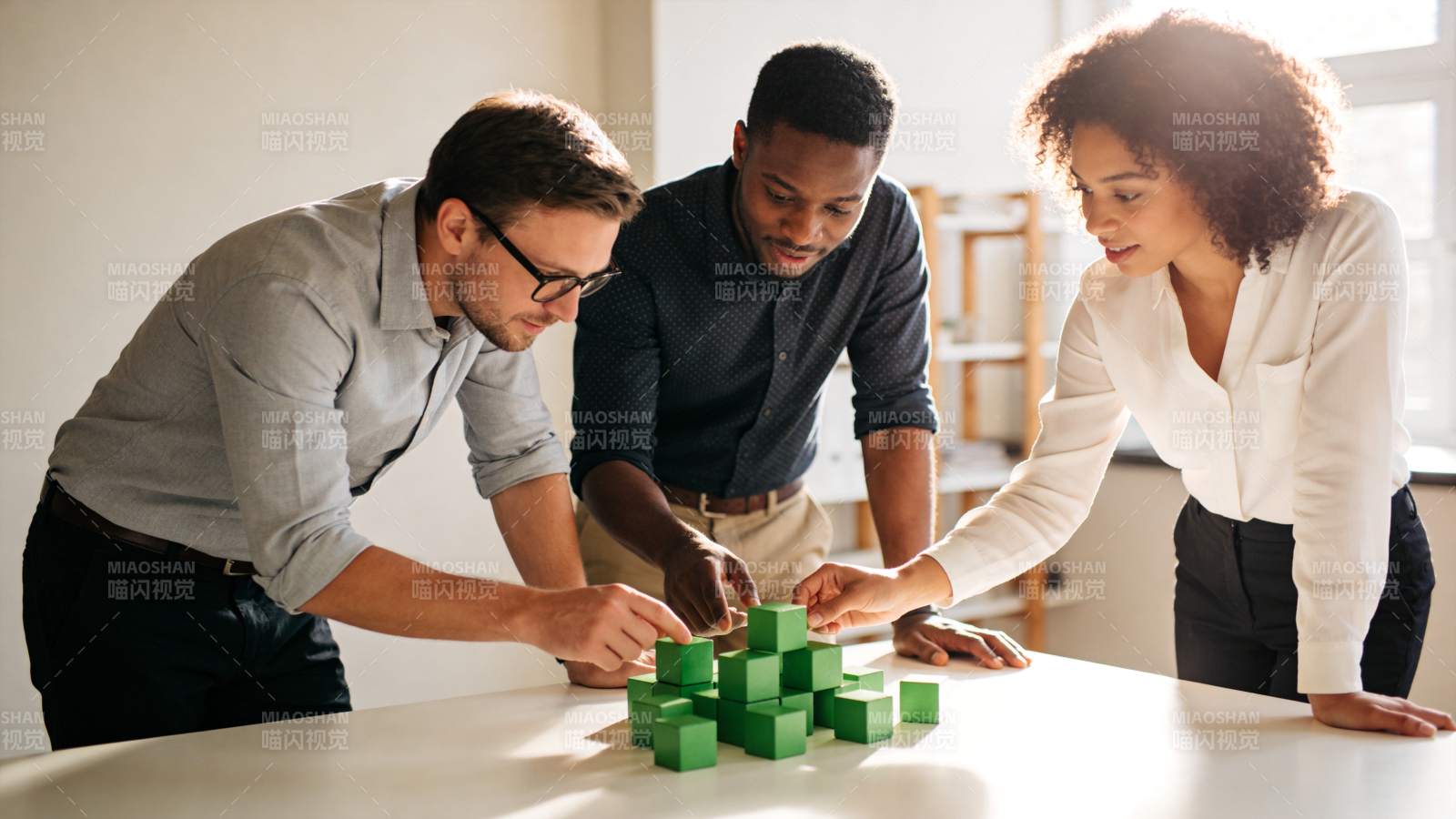 三人协作搭建绿色积木模型场景图片