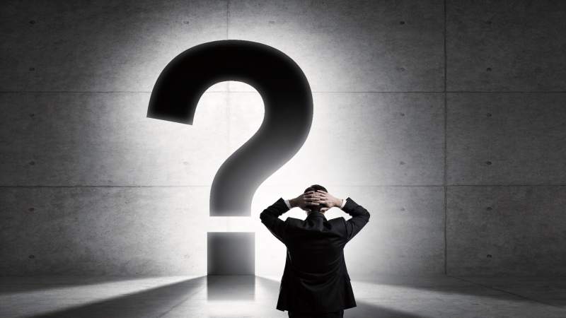 西装男子面对巨大问号陷入沉思图片