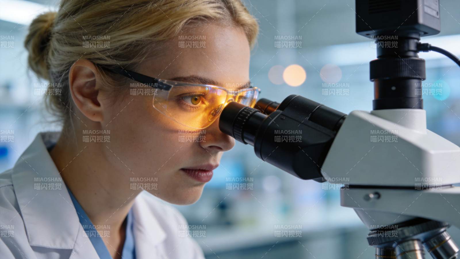 女性科研人员佩戴护目镜使用显微镜观察样本图片