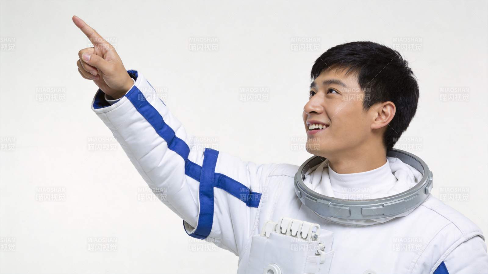 身穿白色宇航服男子抬手指向右上方图片