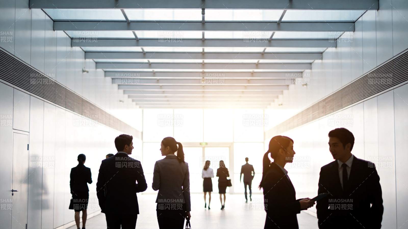 现代办公走廊中多位商务人士行走交谈图片
