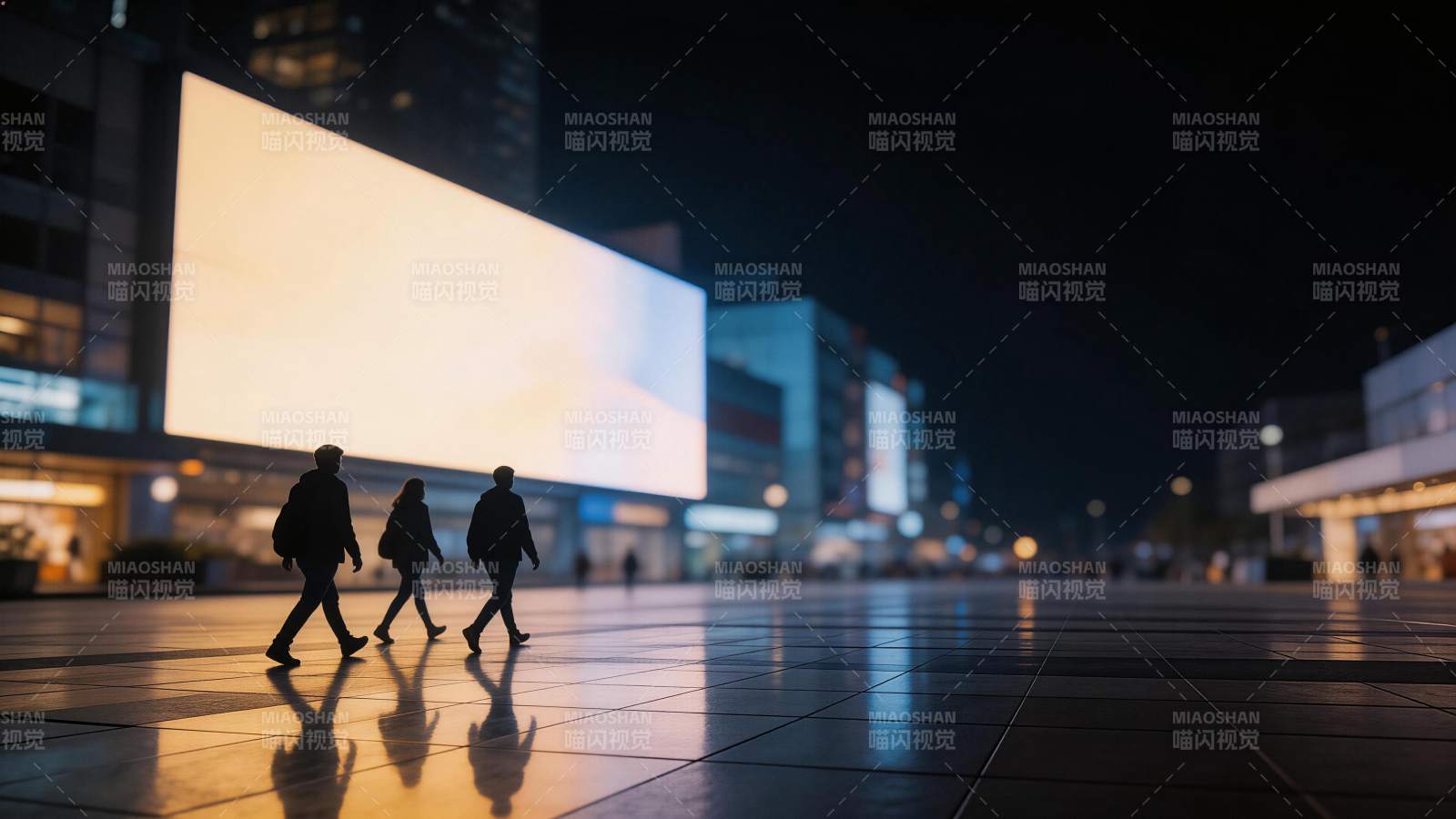 夜晚城市广场三人行走剪影与发光广告屏图片