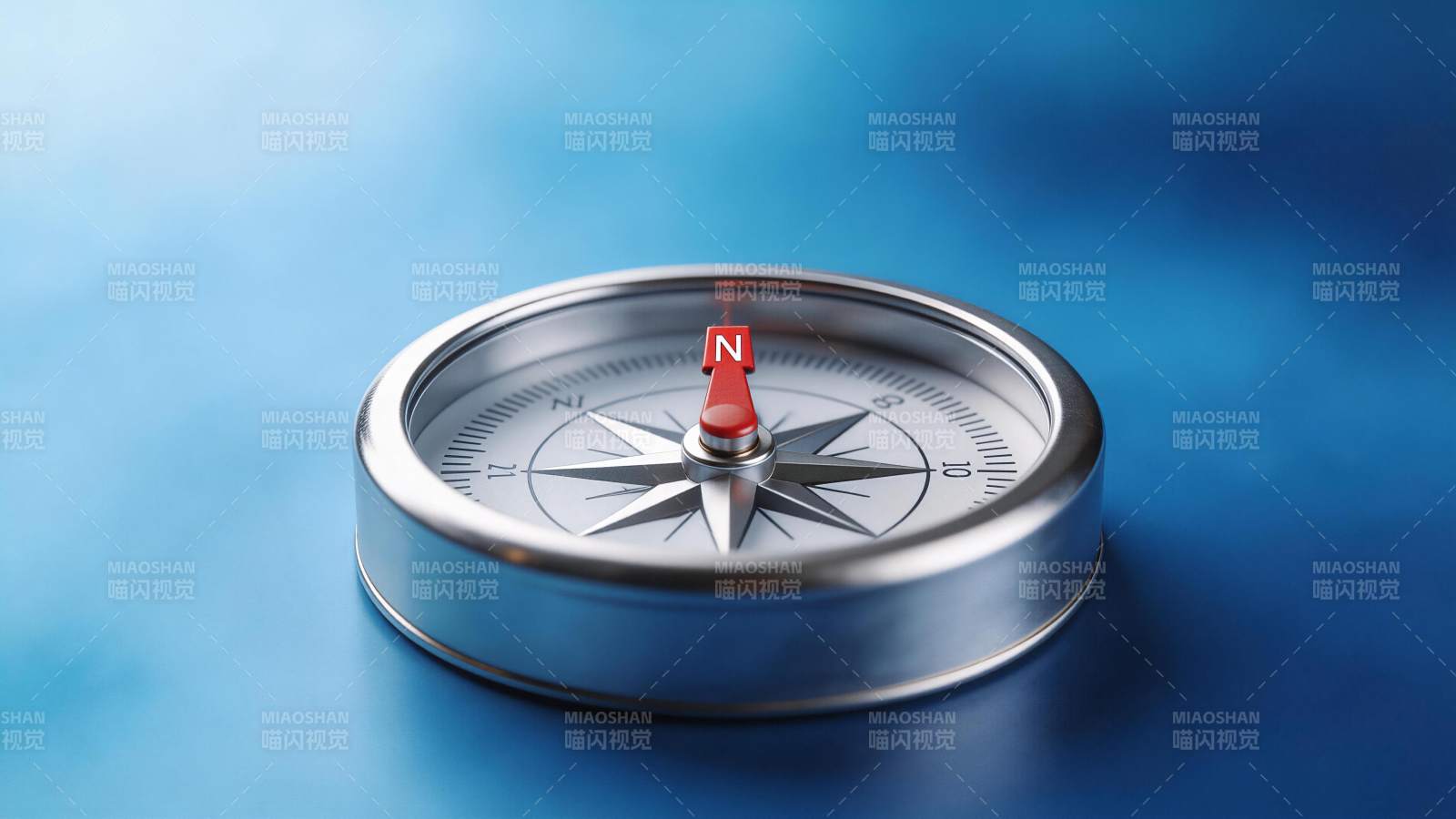 金属指南针置于蓝色背景上指示北方图片