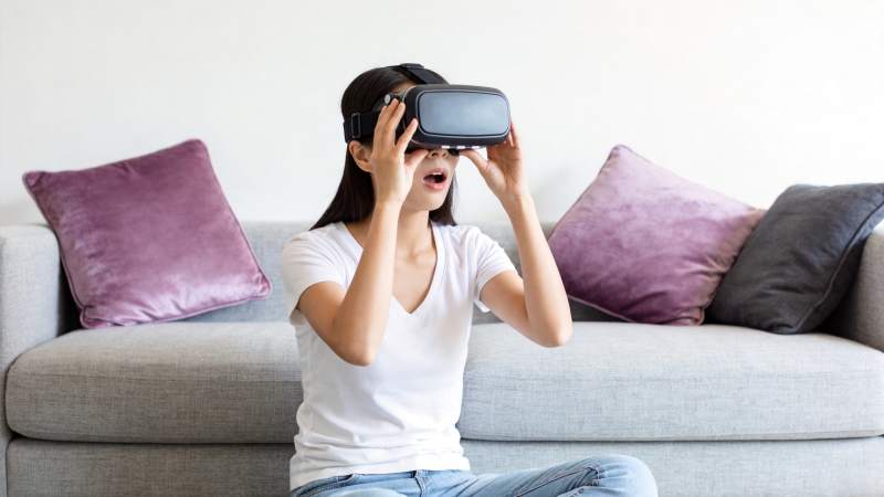 女子佩戴VR眼镜沉浸体验虚拟现实场景图片