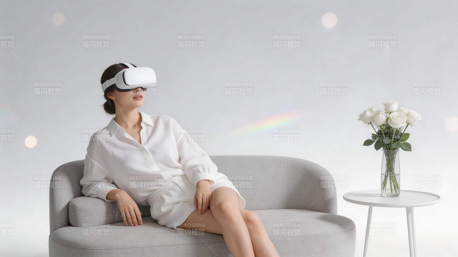 女子佩戴白色VR眼镜坐在灰色沙发上图片