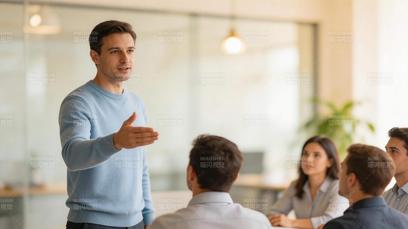 男士站立向多人讲解工作内容场景图片