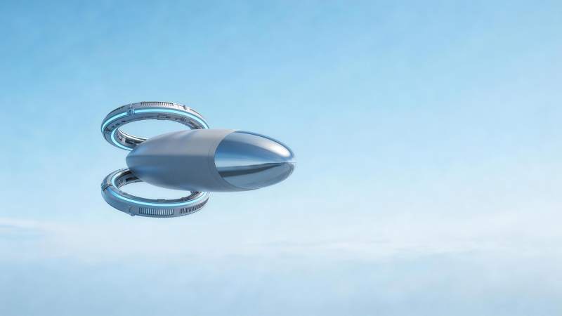 银色飞行器悬浮于蓝天背景中图片