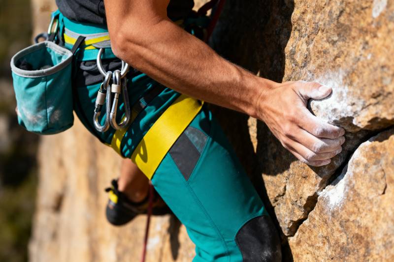 攀岩者紧握岩壁图片