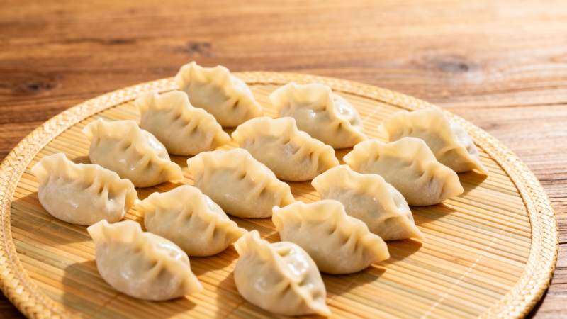 竹盘上的美味饺子图片