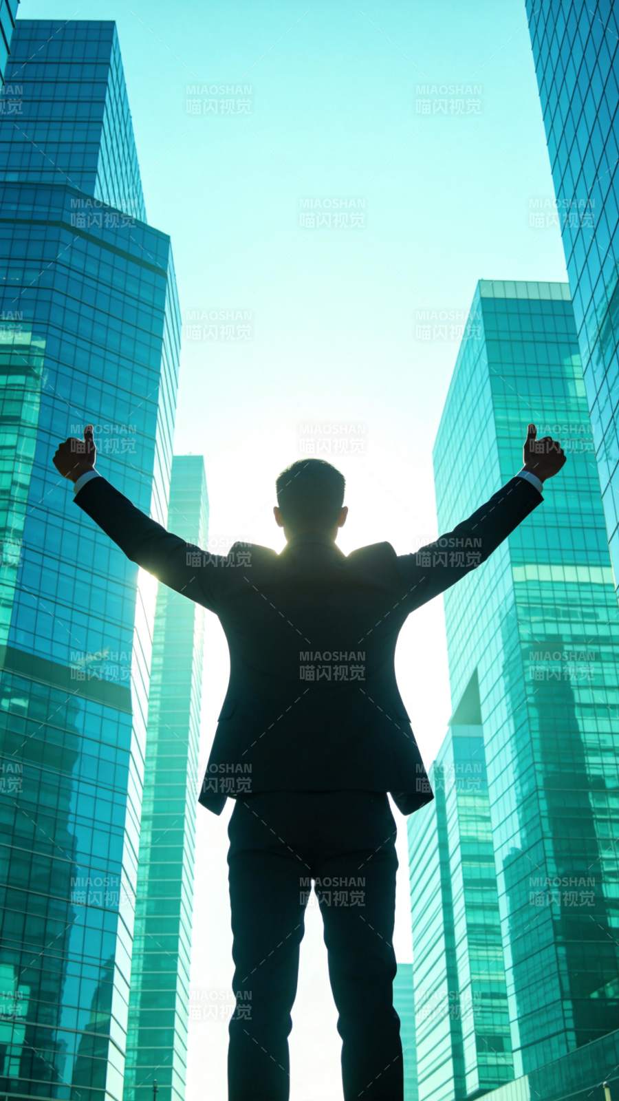 西装男子双臂高举于摩天大楼间图片