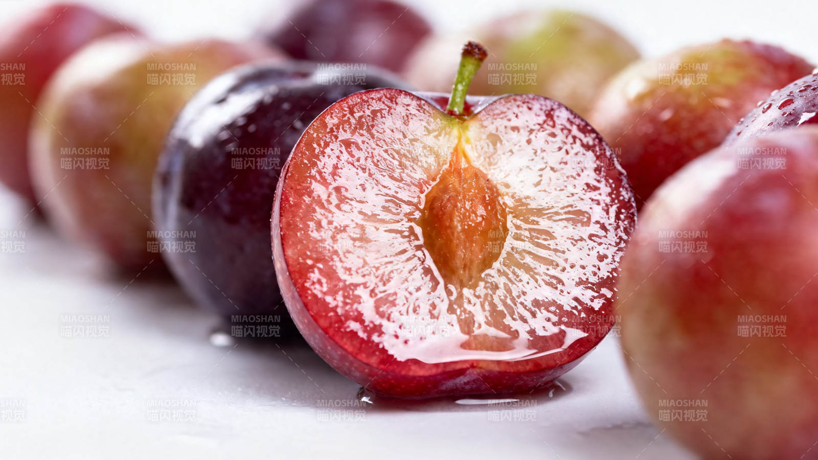 鲜红李子切开 汁水四溢图片