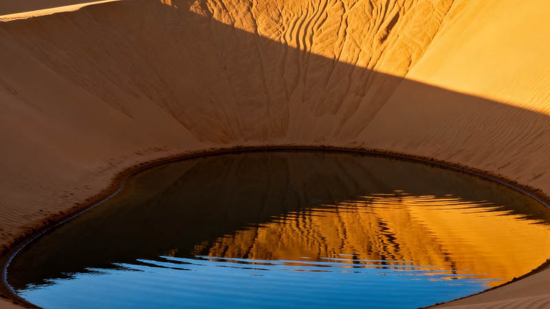 沙漠之眼 沙丘环抱碧湖图片
