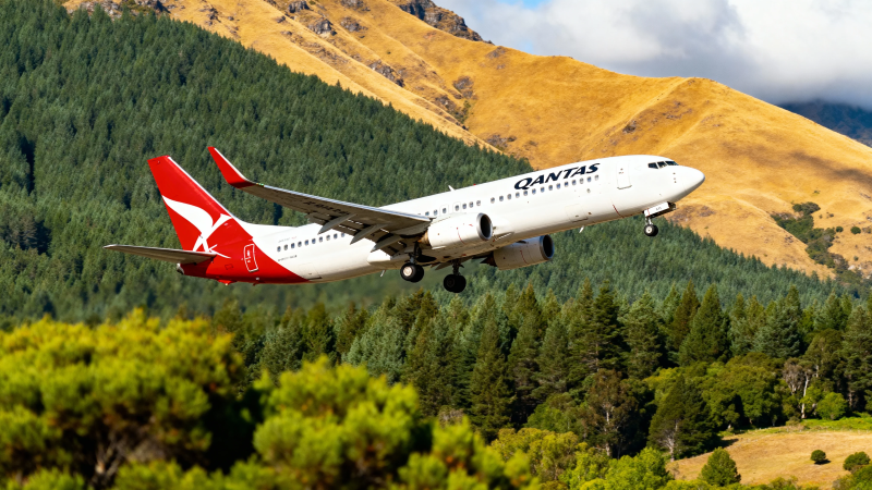 澳航飞机掠过山林起飞图片