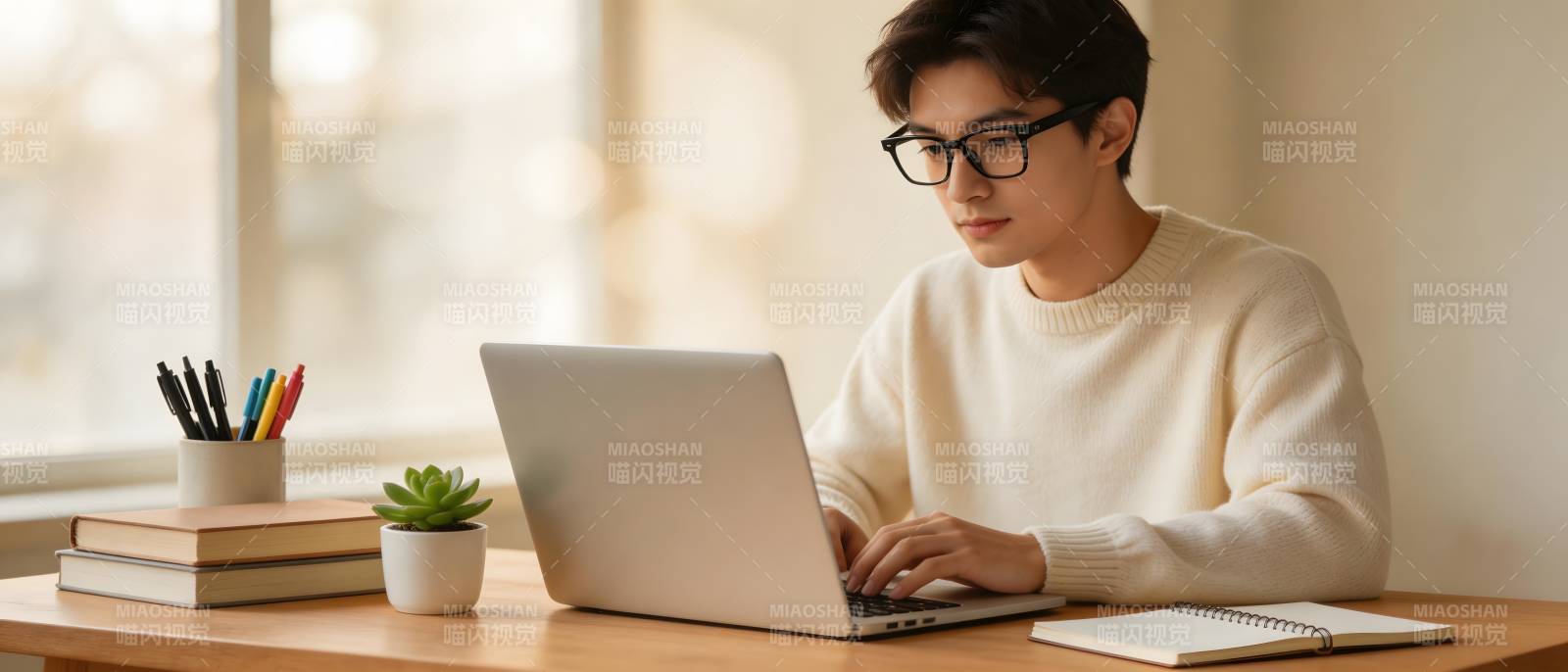 戴眼镜青年窗边用笔记本图片