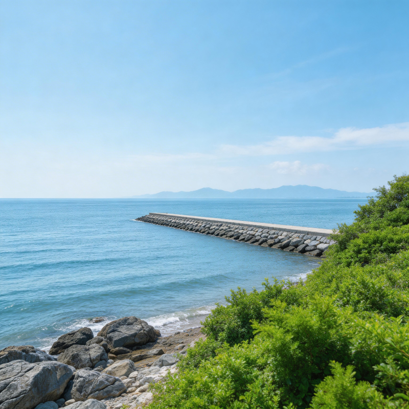 碧海蓝天 石堤延伸至远山图片