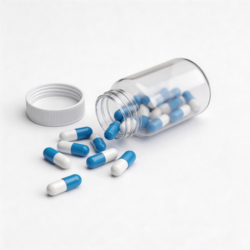 蓝白胶囊散落瓶外图片