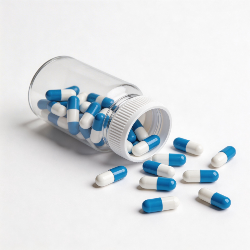 蓝白胶囊散落瓶外图片