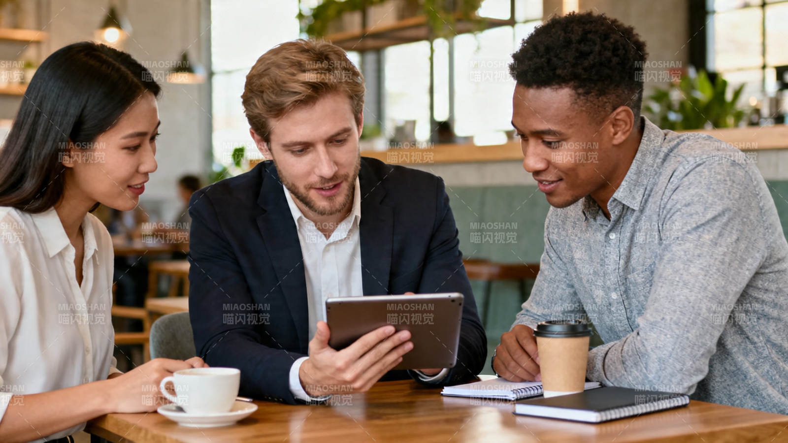 三人围桌看平板讨论图片