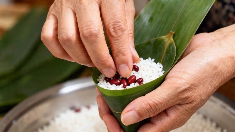 包粽子 糯米红豆入叶中图片