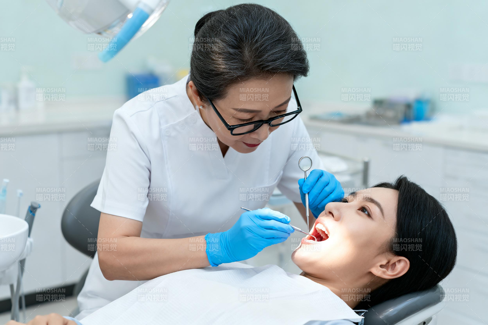 牙医为患者检查口腔图片