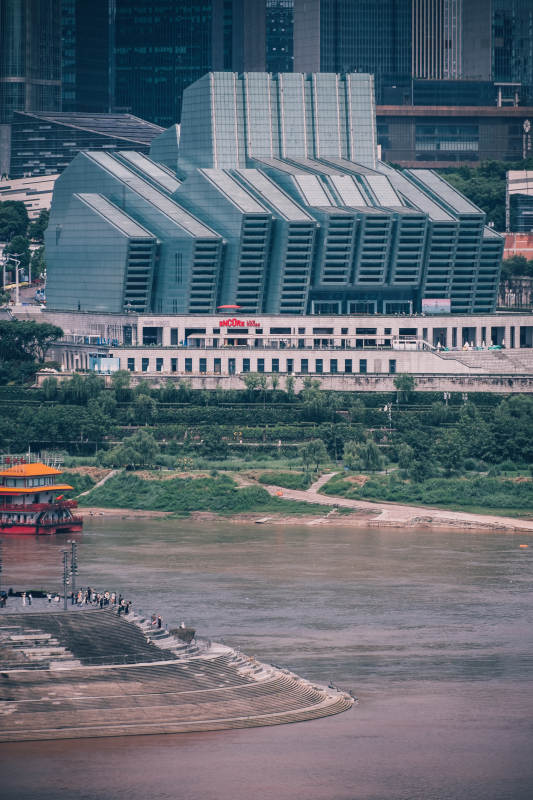 江畔现代建筑群与游船图片