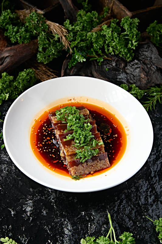 白圆盘装手工切块肉皮冻浇红辣油图片