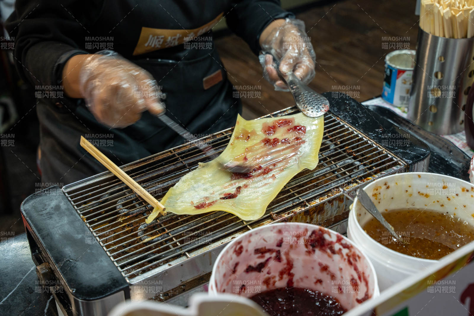 烤乳扇摊主刷酱制作中图片